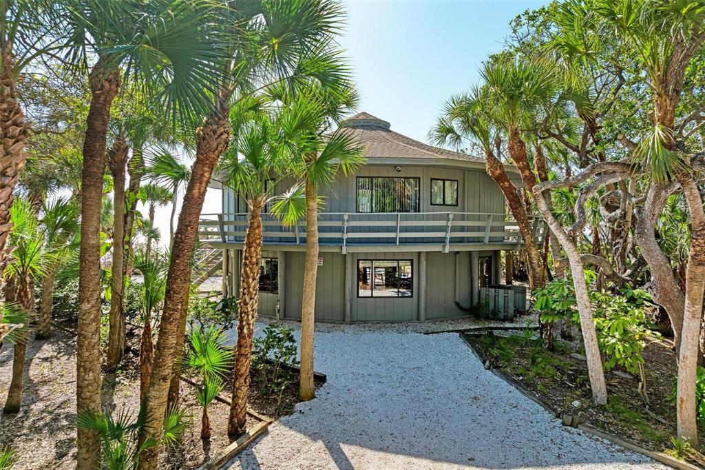 6590 Manasota Key Road Englewood, FL 34223 - Photo 4 of 69 front view of a house with a yard