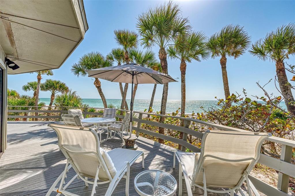 6590 Manasota Key Road Englewood, FL 34223 - Photo 41 of 69 a view of an outdoor space with furniture and umbrella