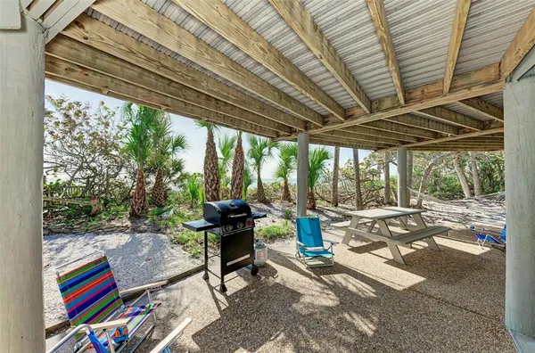 a living room with furniture tv and large windows