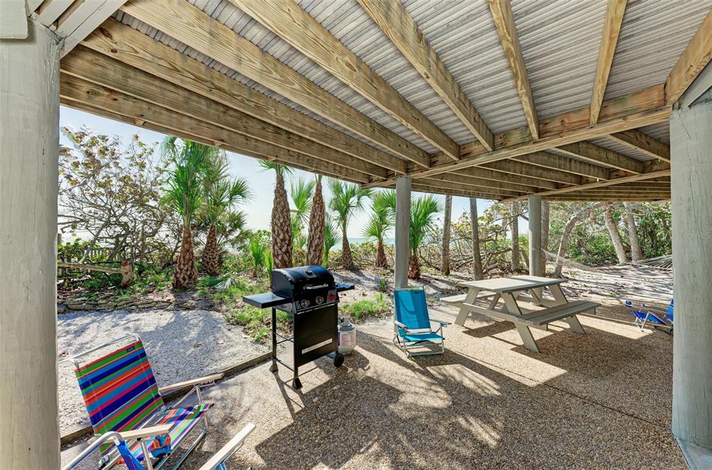 6590 Manasota Key Road Englewood, FL 34223 - Photo 44 of 69 a outdoor space with the couches and dining table with the garden view