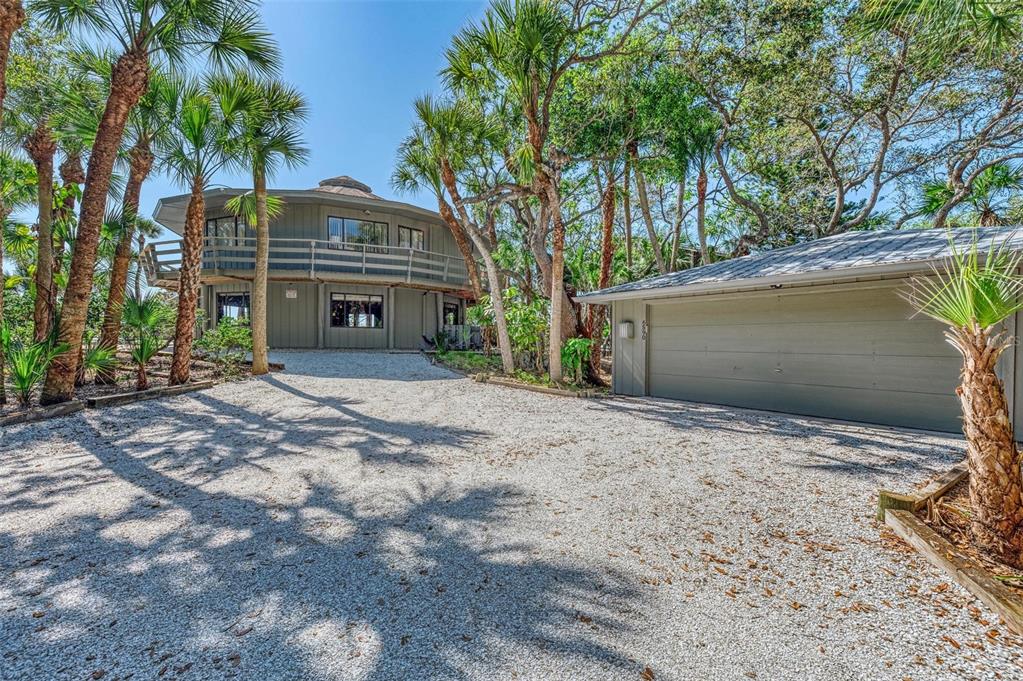 6590 Manasota Key Road Englewood, FL 34223 - Photo 5 of 69 a front view of a house with a yard and garage
