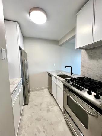 a kitchen with a refrigerator and a sink