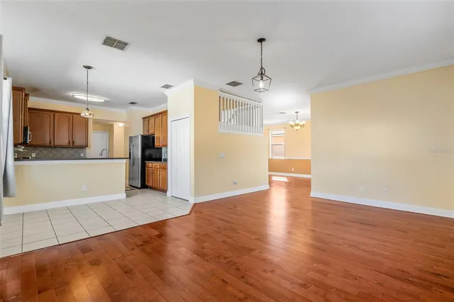 a kitchen with stainless steel appliances a refrigerator and a stove top oven