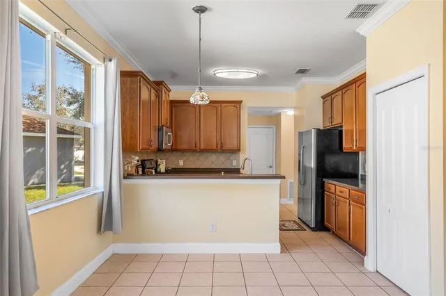 a kitchen with stainless steel appliances granite countertop a sink stove and microwave