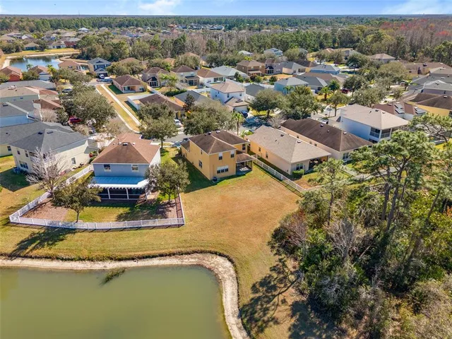 an aerial view of residential house with outdoor space and parking