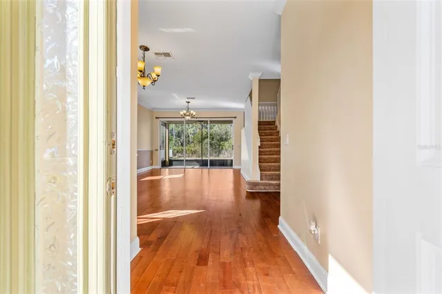 a view of an entryway with wooden floor