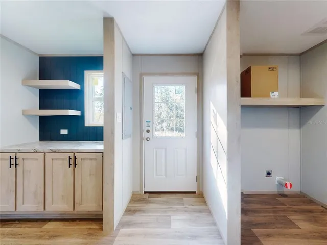 a view of a hallway with wooden floor