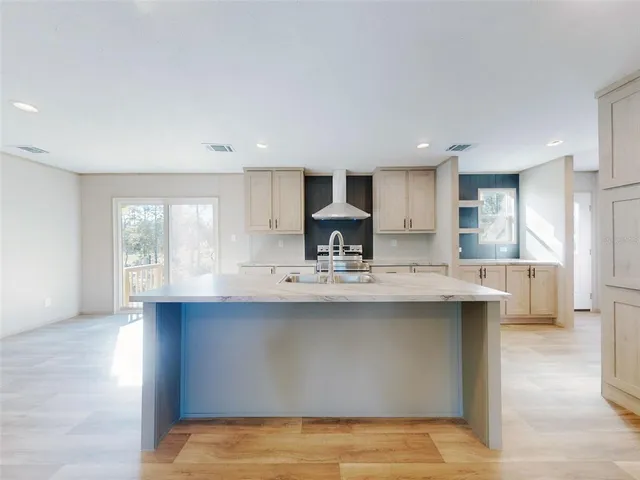 a kitchen with stainless steel appliances granite countertop a sink stove and cabinets
