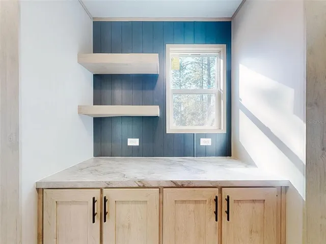 a kitchen with stainless steel appliances granite countertop a refrigerator sink and white cabinets