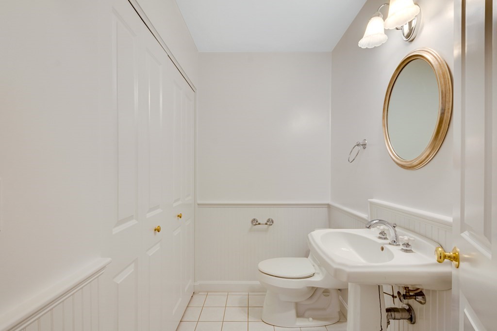 10 Rivard Road, Unit 10 Needham, MA 02492 - Photo 11 of 29 a bathroom with a sink mirror and toilet