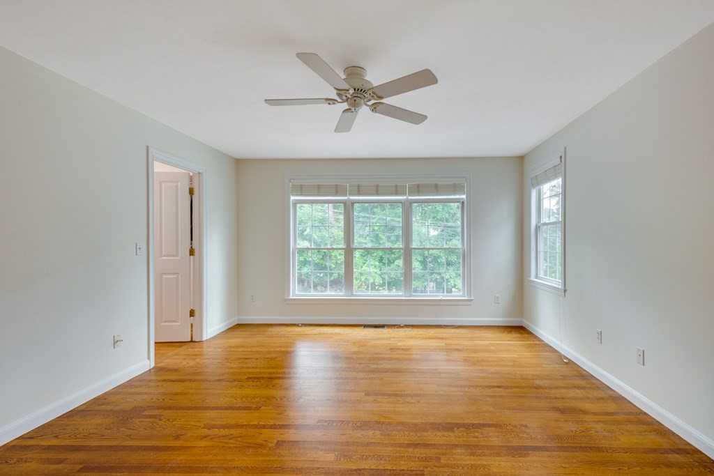 10 Rivard Road, Unit 10 Needham, MA 02492 - Photo 12 of 29 a view of an empty room with wooden floor and a window