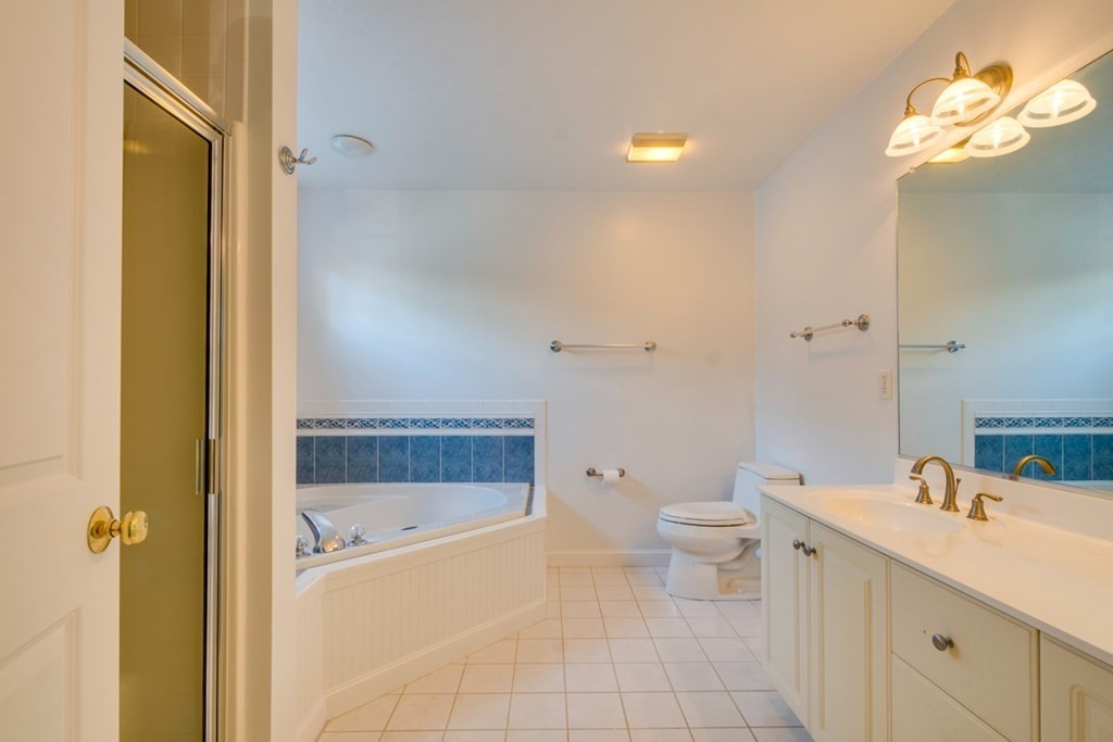 10 Rivard Road, Unit 10 Needham, MA 02492 - Photo 14 of 29 a bathroom with a sink a toilet and shower