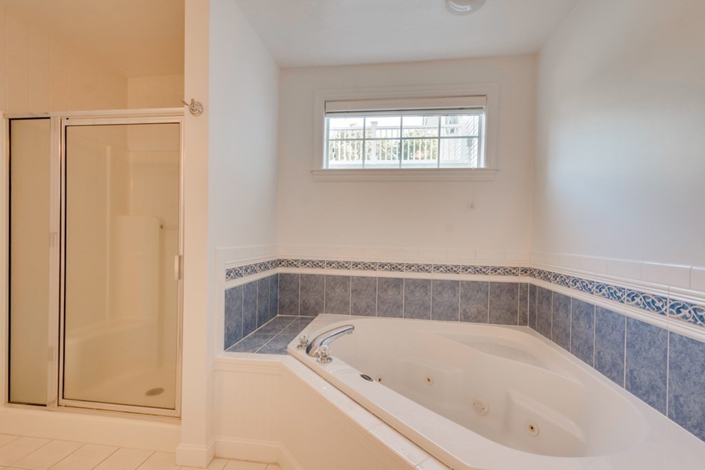 10 Rivard Road, Unit 10 Needham, MA 02492 - Photo 15 of 29 a white bath tub sitting next to a window