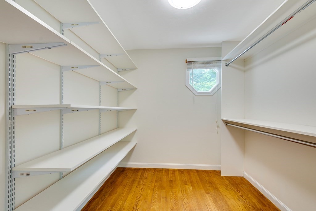 10 Rivard Road, Unit 10 Needham, MA 02492 - Photo 16 of 29 a room with walk in closet and wooden floor