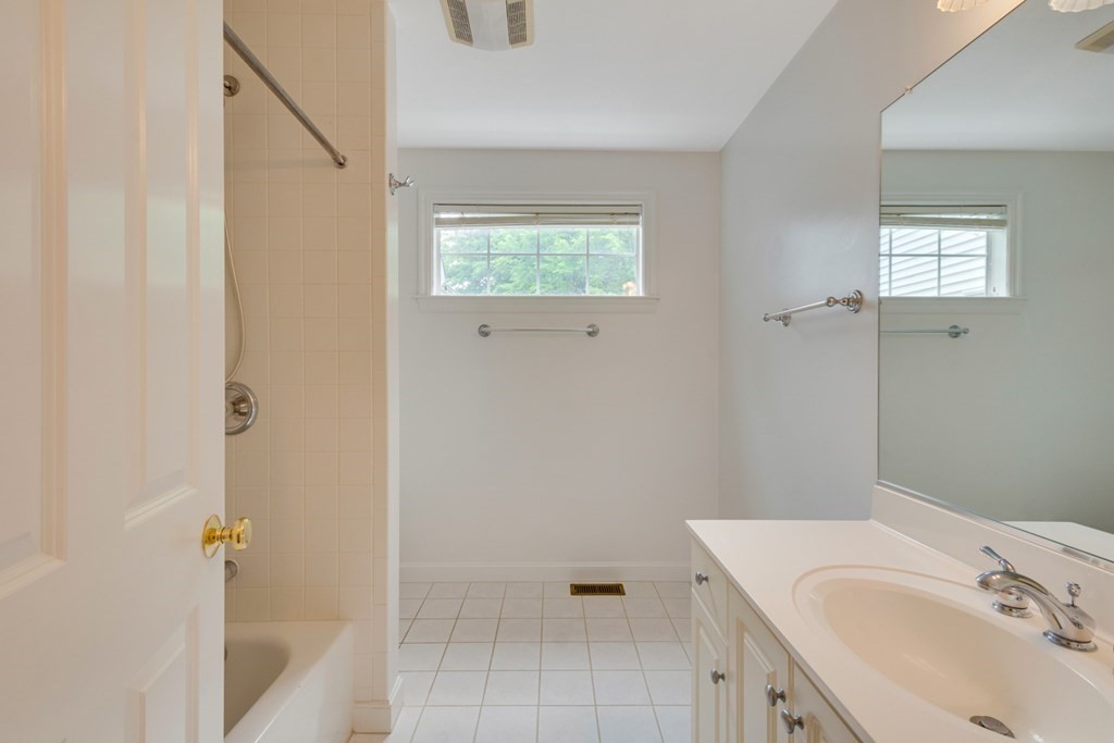 10 Rivard Road, Unit 10 Needham, MA 02492 - Photo 22 of 29 a bathroom with a sink and a mirror