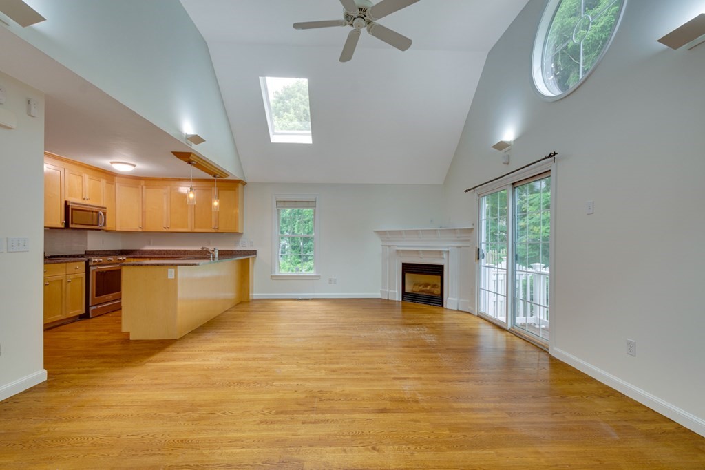 10 Rivard Road, Unit 10 Needham, MA 02492 - Photo 4 of 29 a view of a kitchen with a sink and a fireplace