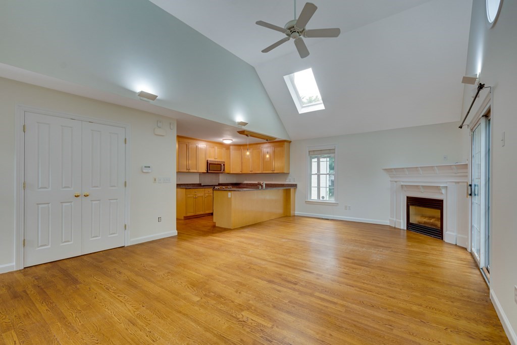 10 Rivard Road, Unit 10 Needham, MA 02492 - Photo 5 of 29 a view of empty room with wooden floor and fireplace