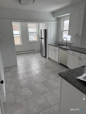 a kitchen with a sink a stove and refrigerator