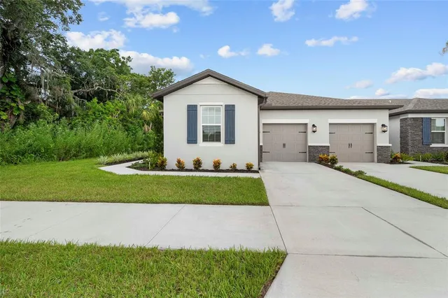 a front view of a house with a yard and garage