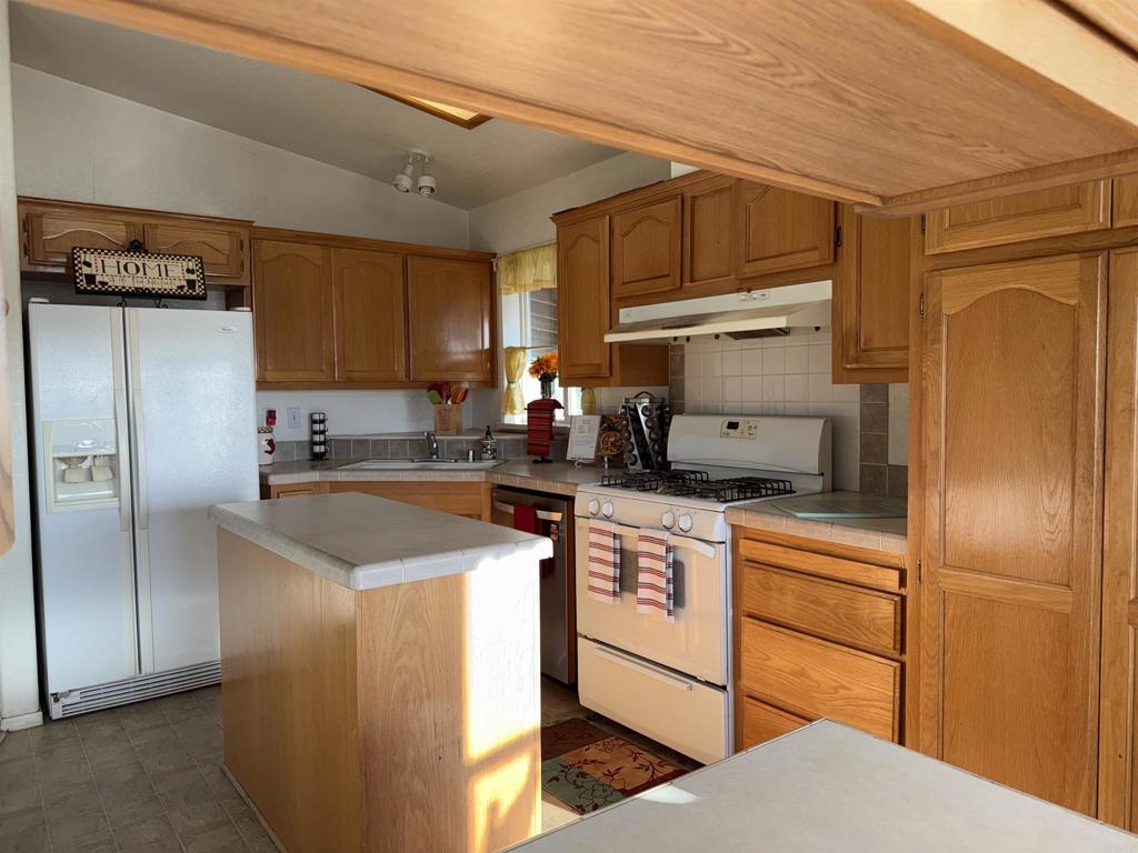 37697 Montezuma Valley Road Ranchita, CA 92066 - Photo 14 of 47 a kitchen with stainless steel appliances granite countertop a refrigerator a sink and a stove