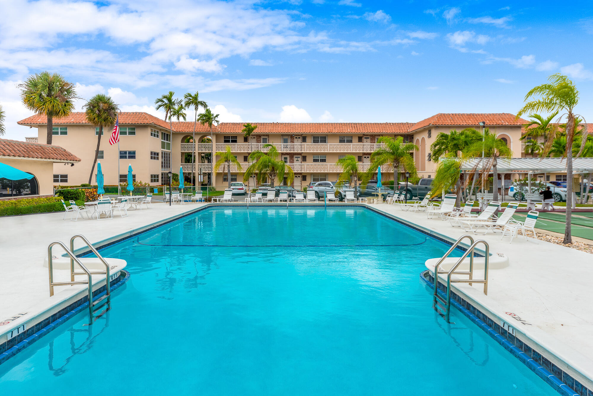 400 Northeast 20th Street, Unit D307 Boca Raton, FL 33431 - Photo 1 of 34 a view of a swimming pool with outdoor seating