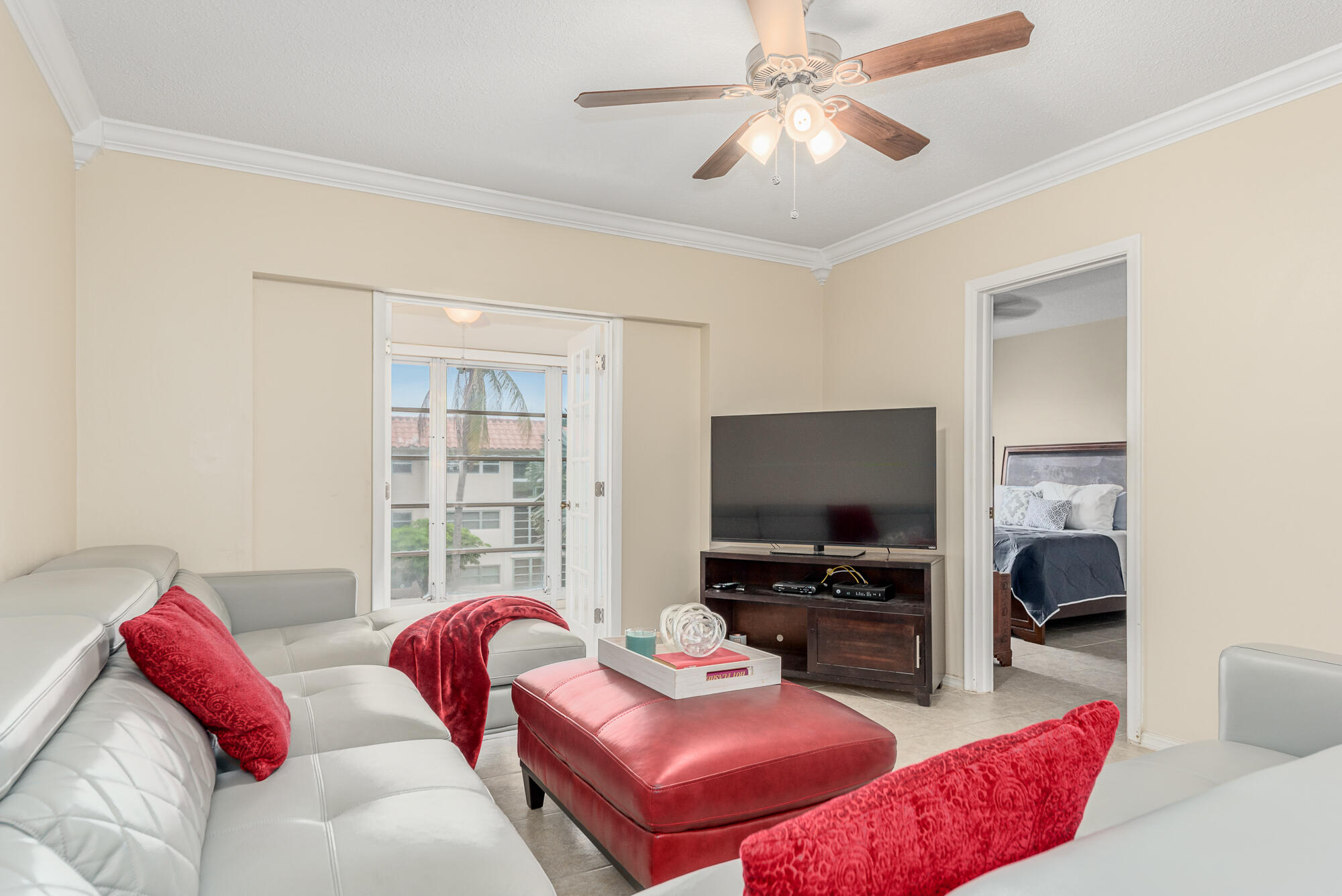 400 Northeast 20th Street, Unit D307 Boca Raton, FL 33431 - Photo 12 of 34 a living room with furniture and a flat screen tv