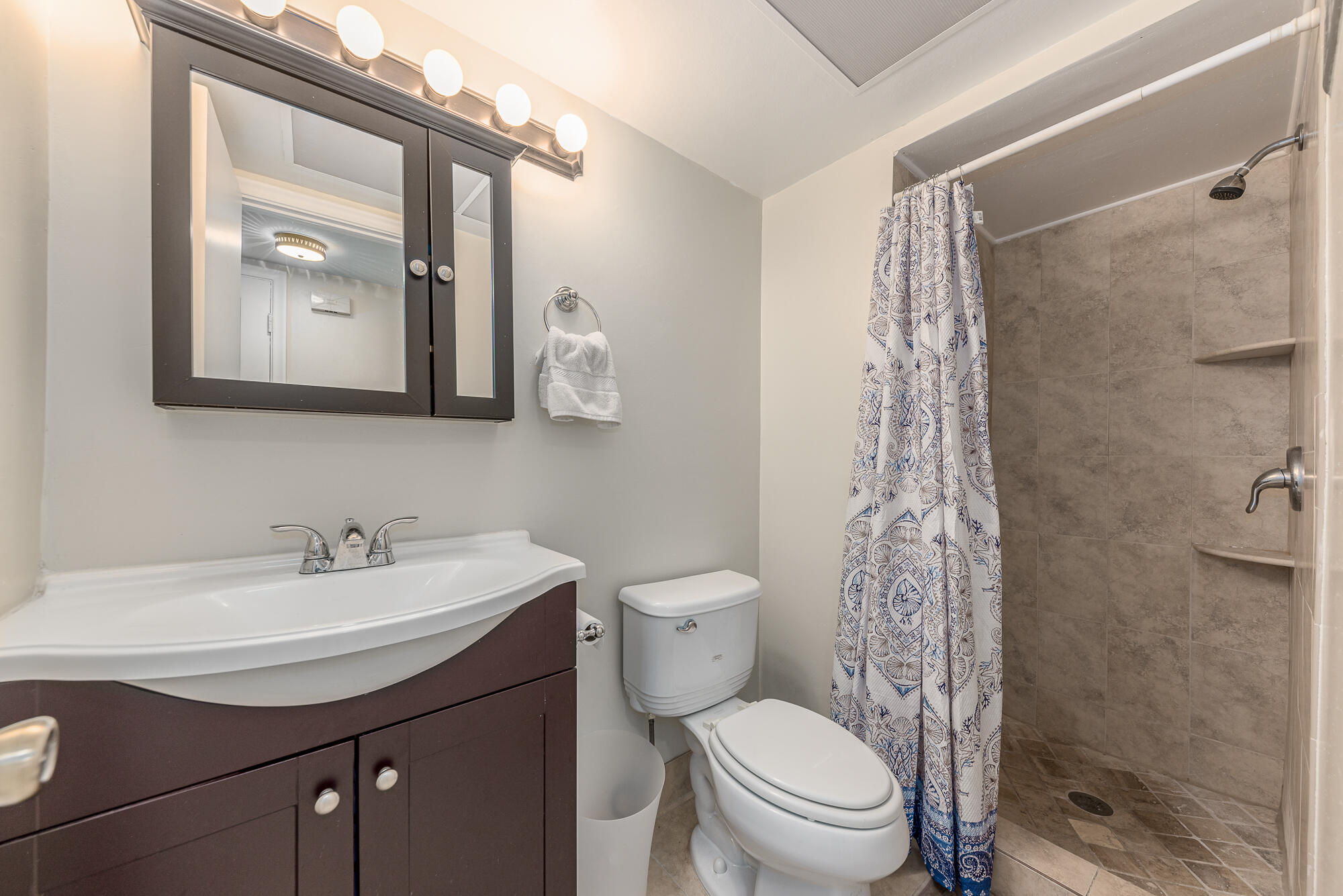 400 Northeast 20th Street, Unit D307 Boca Raton, FL 33431 - Photo 25 of 34 a bathroom with a toilet sink and mirror