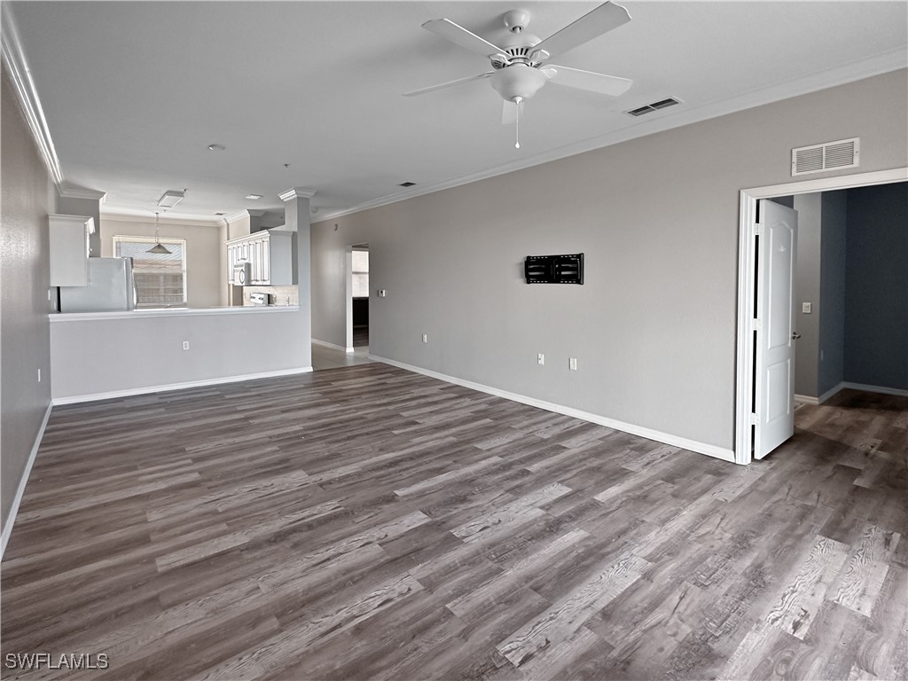 8451 Kingbird Loop, Unit 345 Estero, FL 33967 - Photo 2 of 10 wooden floor in an empty room with a window