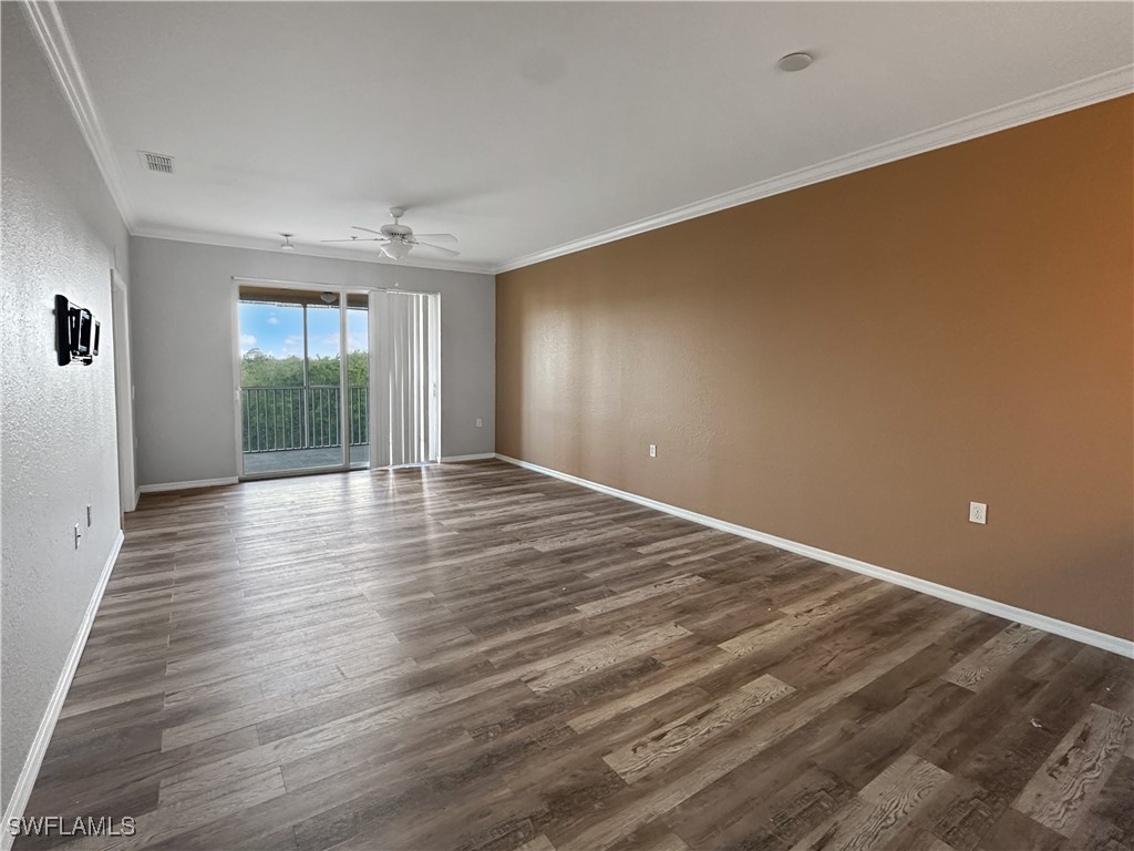8451 Kingbird Loop, Unit 345 Estero, FL 33967 - Photo 3 of 10 wooden floor in an empty room with a window