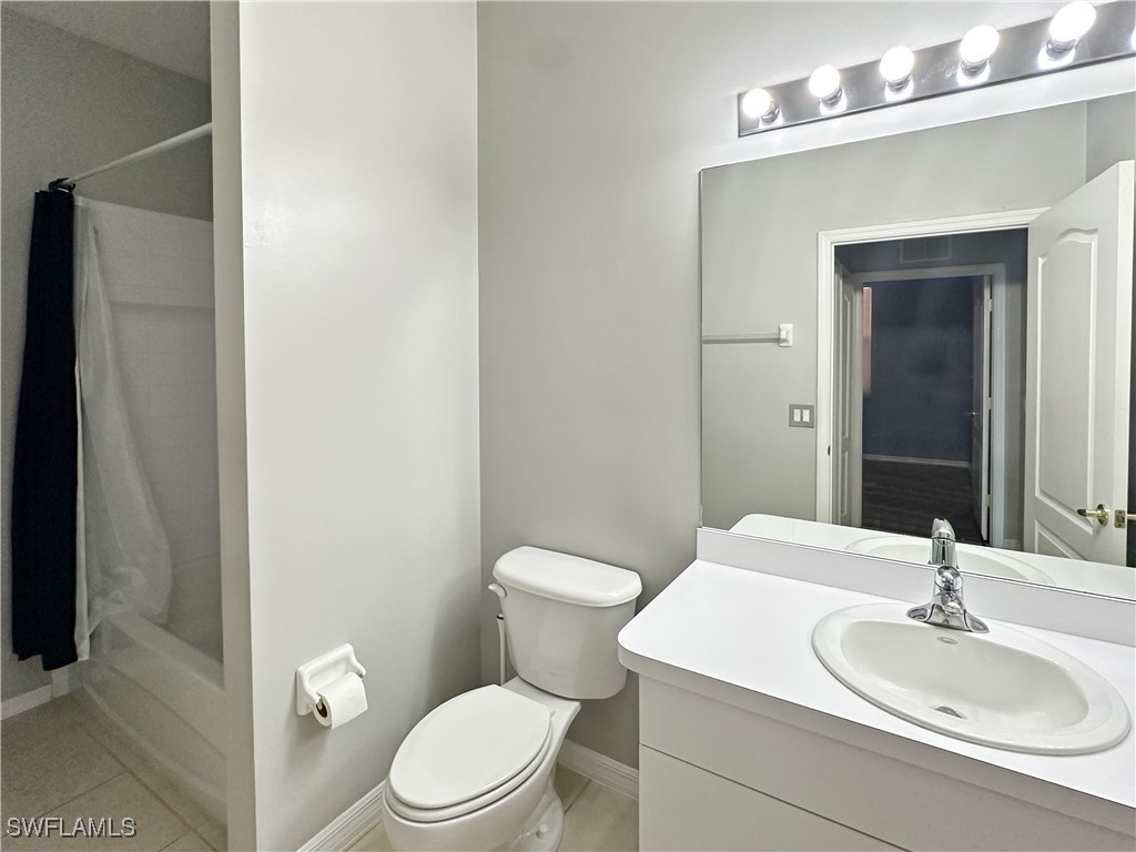 8451 Kingbird Loop, Unit 345 Estero, FL 33967 - Photo 10 of 10 a bathroom with a sink a toilet and mirror