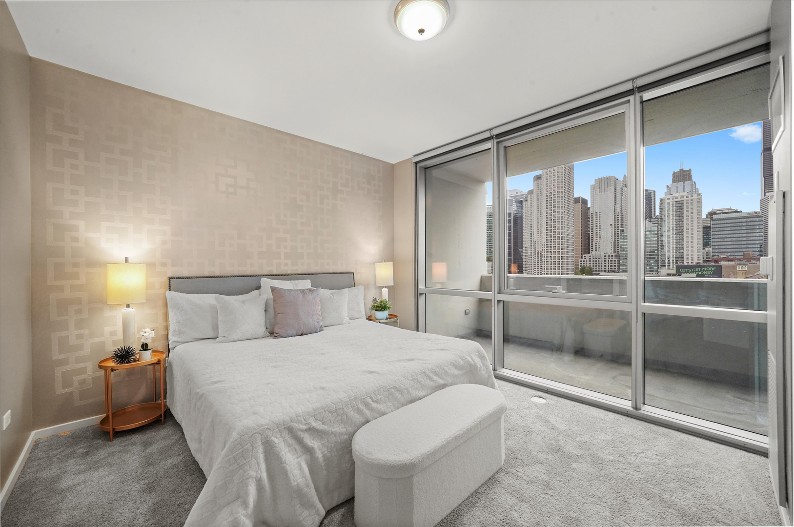 125 South Green Street, Unit 806A Chicago, IL 60607 - Photo 14 of 35 a bedroom with a large bed and a chandelier