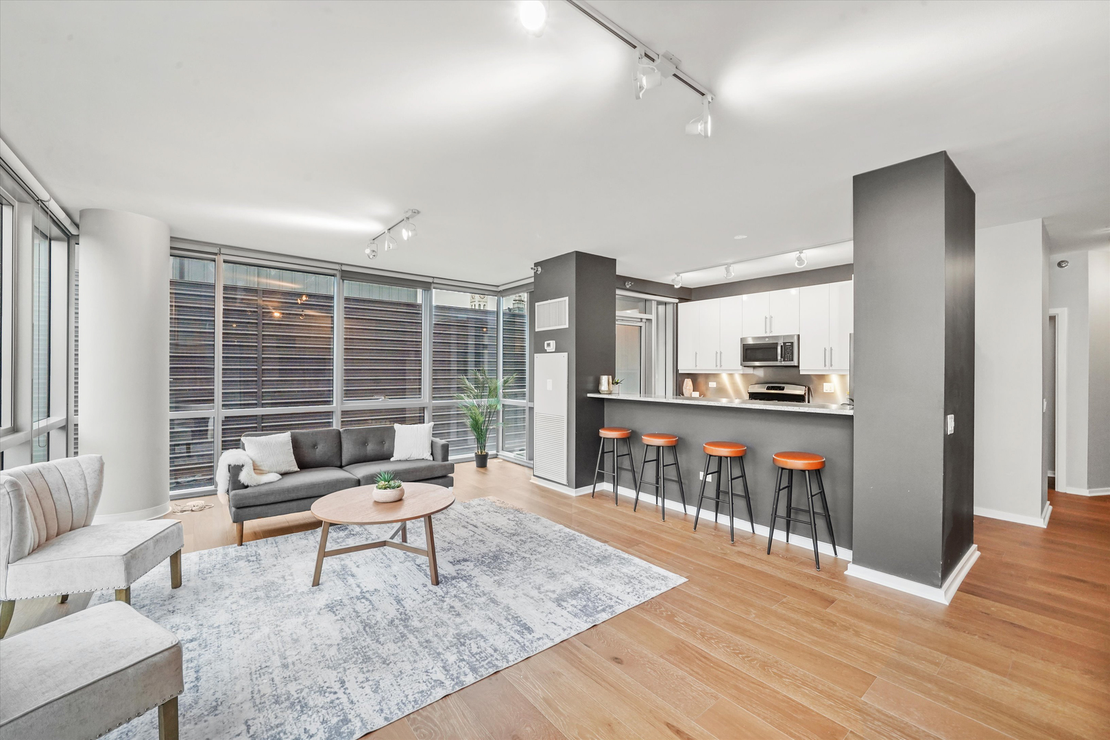 125 South Green Street, Unit 806A Chicago, IL 60607 - Photo 8 of 35 a living room with furniture and a wooden floor