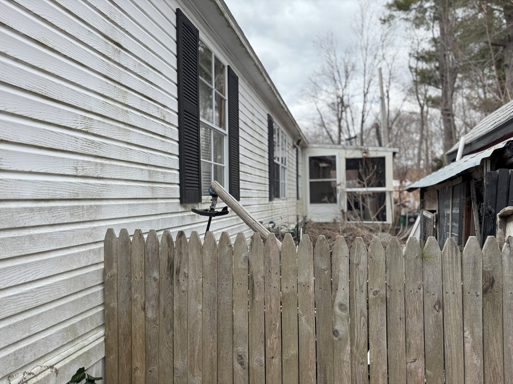3 Adams Street Salisbury, MA 01952 - Photo 7 of 10 a view of a house with a wooden fence