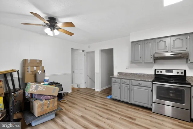 a kitchen with a stove a sink and a refrigerator
