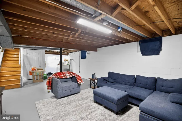 a living room with furniture a couch and a window