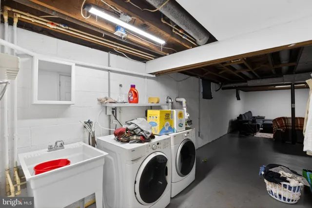 a utility room with dryer washer and closet