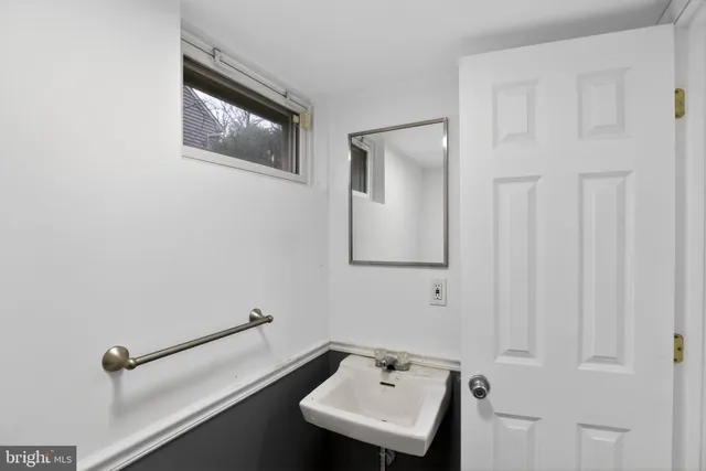 a bathroom with a sink and mirror