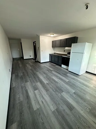 a view of room with furniture and wooden floor