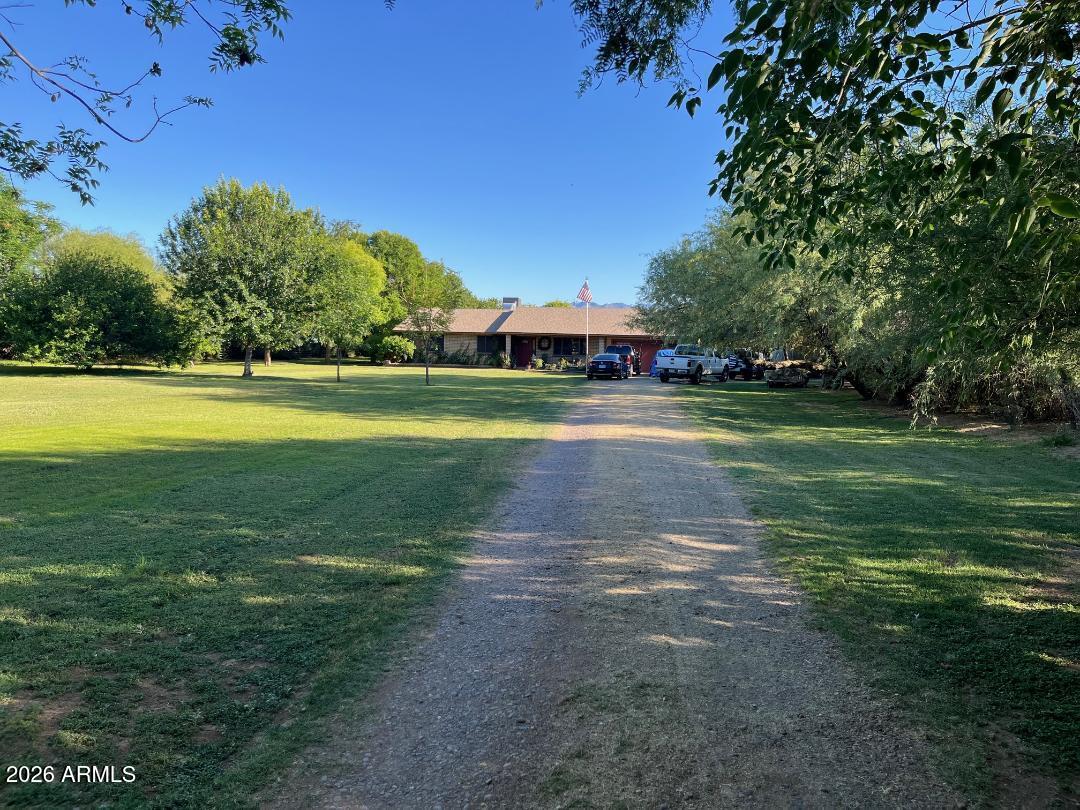 9115 West Broadway Road Tolleson, AZ 85353 - Photo 1 of 13 a view of a big yard with large trees
