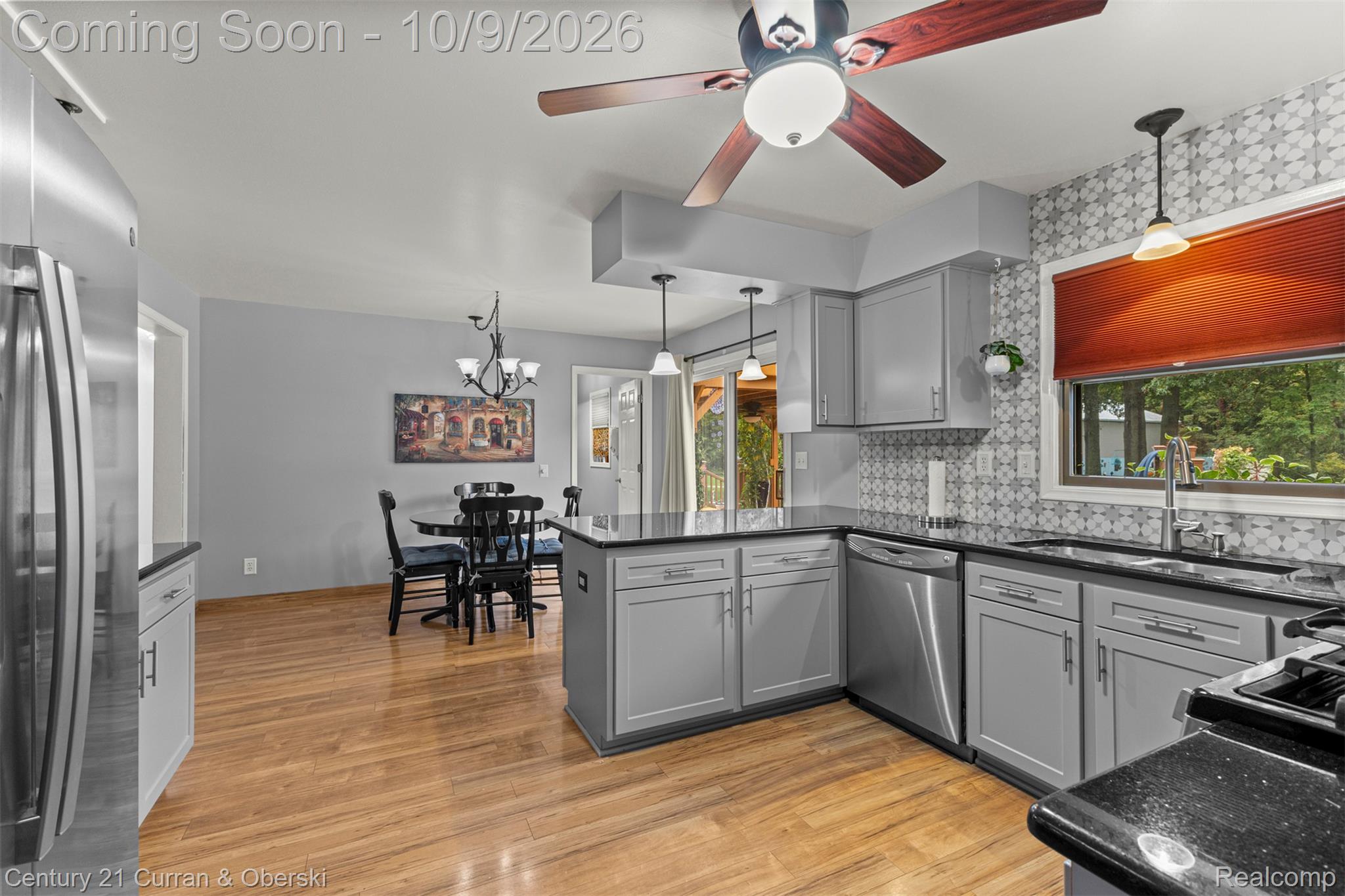43040 Willis Road Belleville, MI 48111 - Photo 19 of 65 Kitchen featuring grey cabinetry, stainless steel appliances, wood-finish flooring, and pendant lighting
