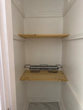 a kitchen with white cabinets and white appliances
