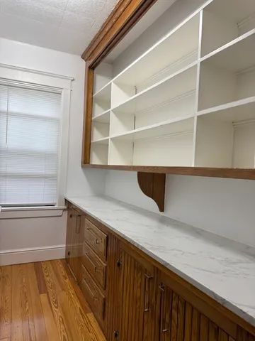 a room with a bed and a dresser