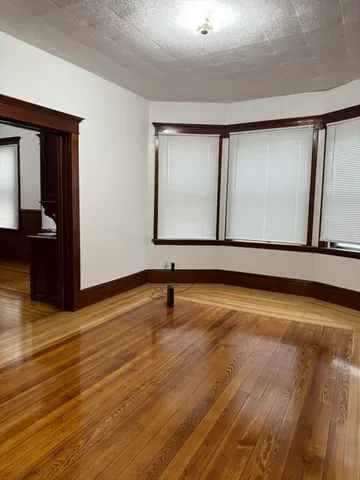 a view of a room with wooden floor