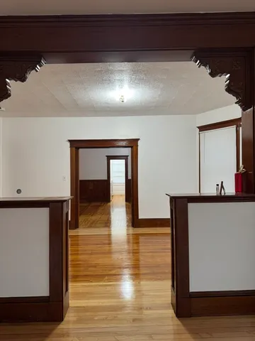 a view of an empty room with wooden floor
