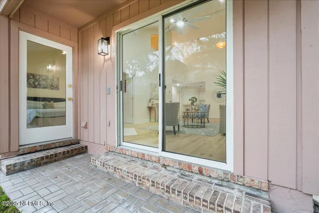 a view of a house with a yard and tree