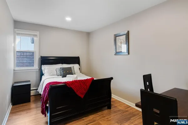 a view of bedroom with a bed and a dresser