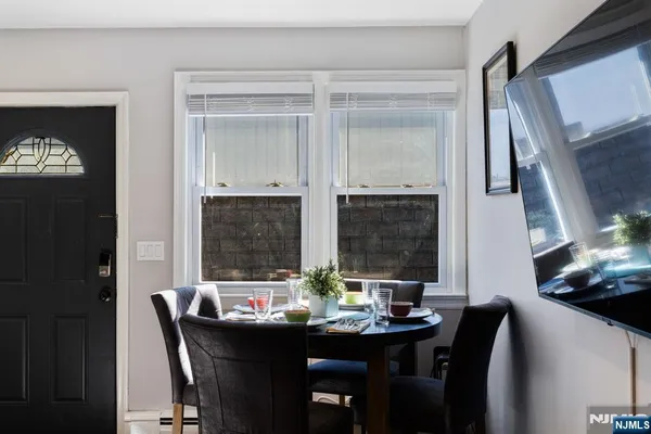 a view of a dining room with furniture and window