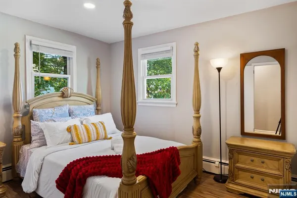 a bedroom with a bed and a mirror