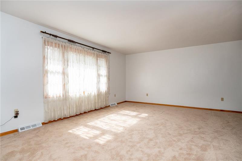 309 Stone Quarry Road Monaca, PA 15061 - Photo 6 of 12 Living room with large picture window and brand new carpet.