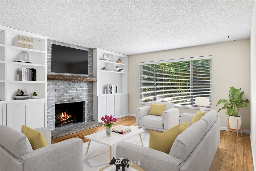 16505 23rd Avenue Southeast Bothell, WA 98012 - Photo 2 of 33 a living room with furniture a flat screen tv and a fireplace